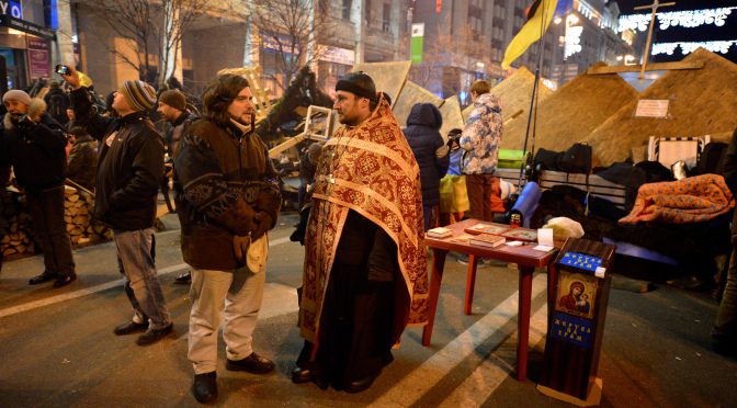 Priest on duty during Euromaidan, December 2013. Photographer: Ivan Bandura
