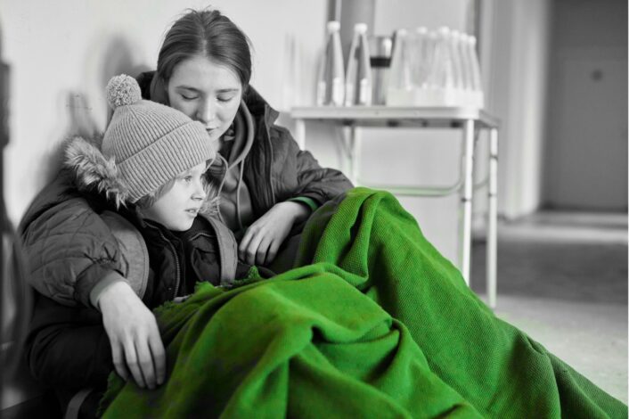 A woman and girl sharing a blanket