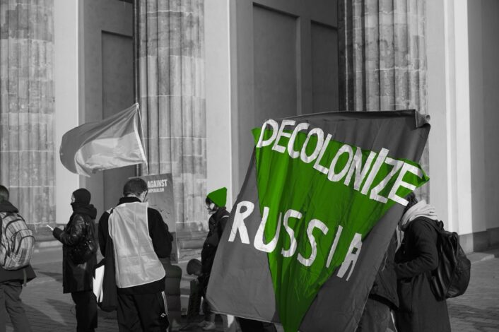 Protesters with "Decolonize Russia" sign